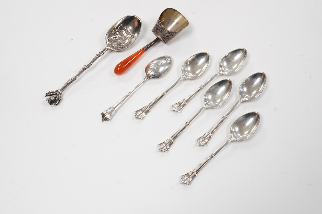 A collection of assorted silver to include five napkin rings including two pairs, a cased pair of glass butter dishes with silver butter knives, five golf related teaspoons, a cased set of six sterling cocktail sticks wi